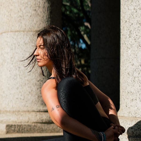 A person sitting in a cross-legged meditation pose, symbolizing balance.